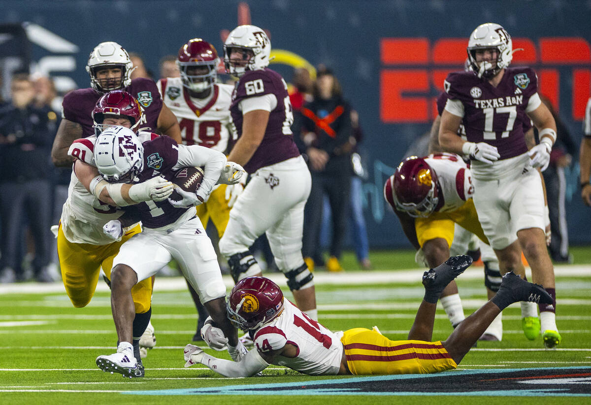 Texas A&M Aggies wide receiver Jabre Barber (1) battles for yards as USC Trojans defensive ...