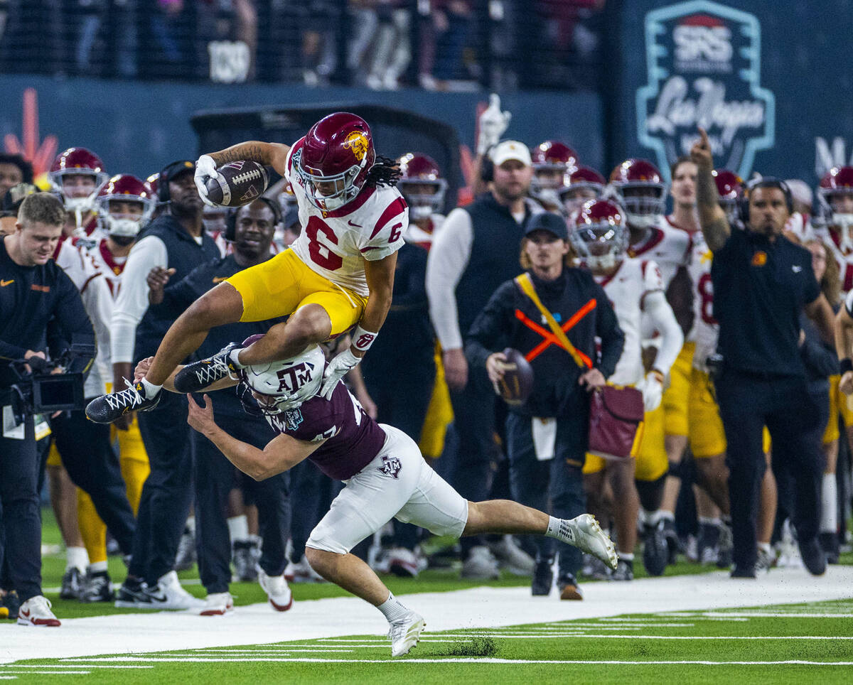 USC Trojans wide receiver Makai Lemon (6) leaps over Texas A&M Aggies place kicker Randy Bo ...