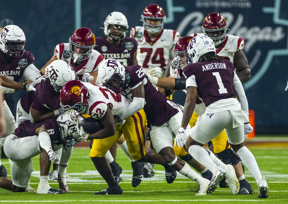 USC Trojans running back A'Marion Peterson (22) battles for more yards as Texas A&M Aggies ...