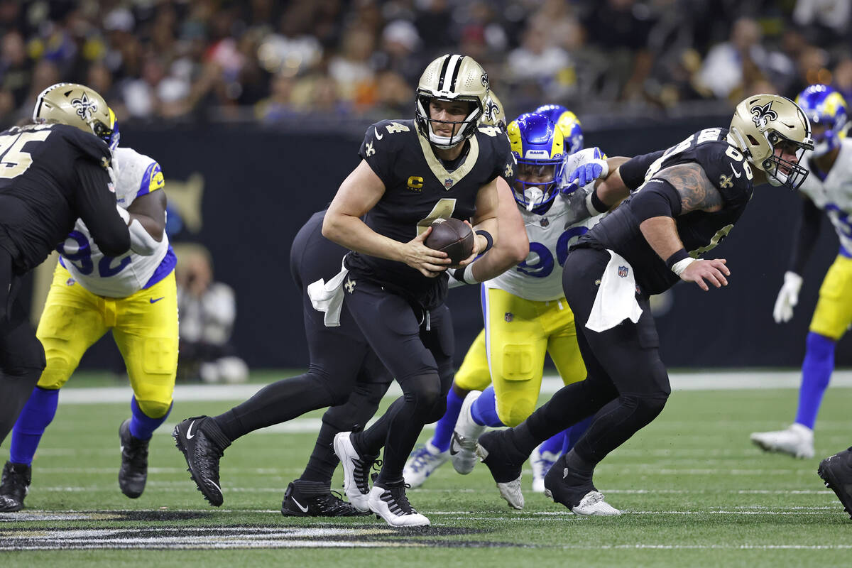 New Orleans Saints quarterback Derek Carr (4) looks to pass during an NFL football game against ...