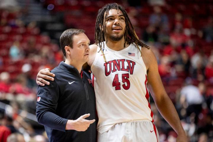 UNLV head coach Kevin Kruger and forward Jeremiah Cherry (45) hug during the college basketball ...