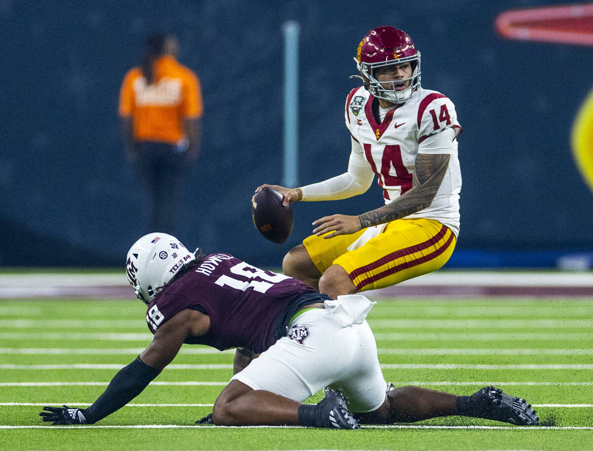 USC Trojans quarterback Jayden Maiava (14) scrambles out of a sack attempt by Texas A&M Agg ...