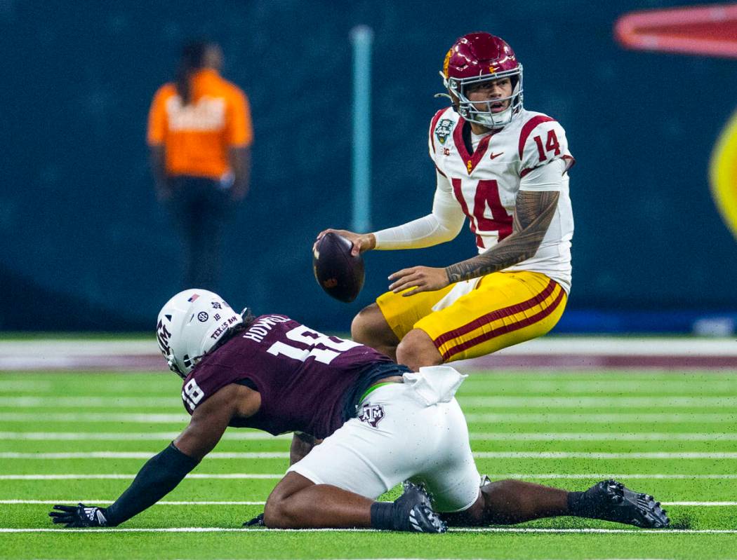 USC Trojans quarterback Jayden Maiava (14) scrambles out of a sack attempt by Texas A&M Agg ...