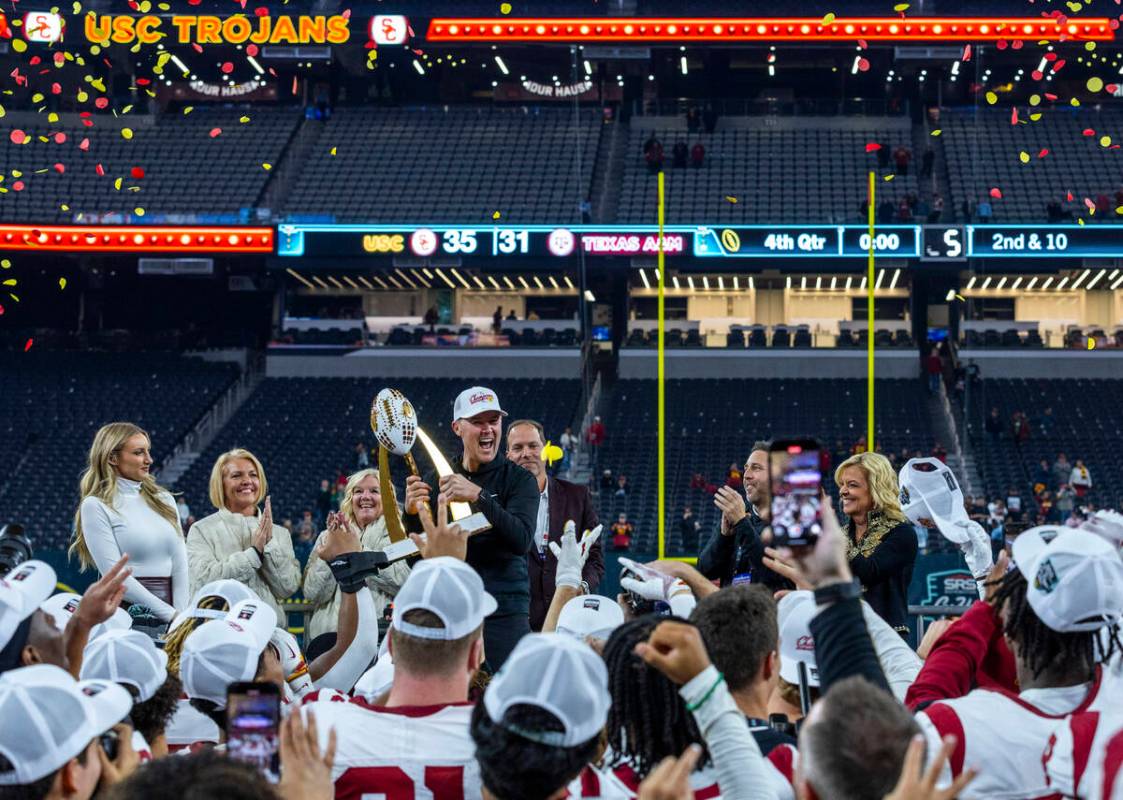 USC Trojans head coach Lincoln Riley holds the trophy as the celebrate their win over the Texas ...