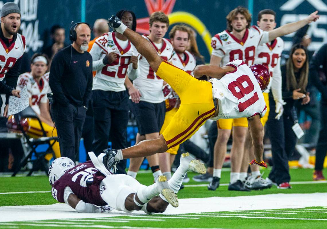 USC Trojans wide receiver Kyle Ford (81) is upended after a catch and run by Texas A&M Aggi ...