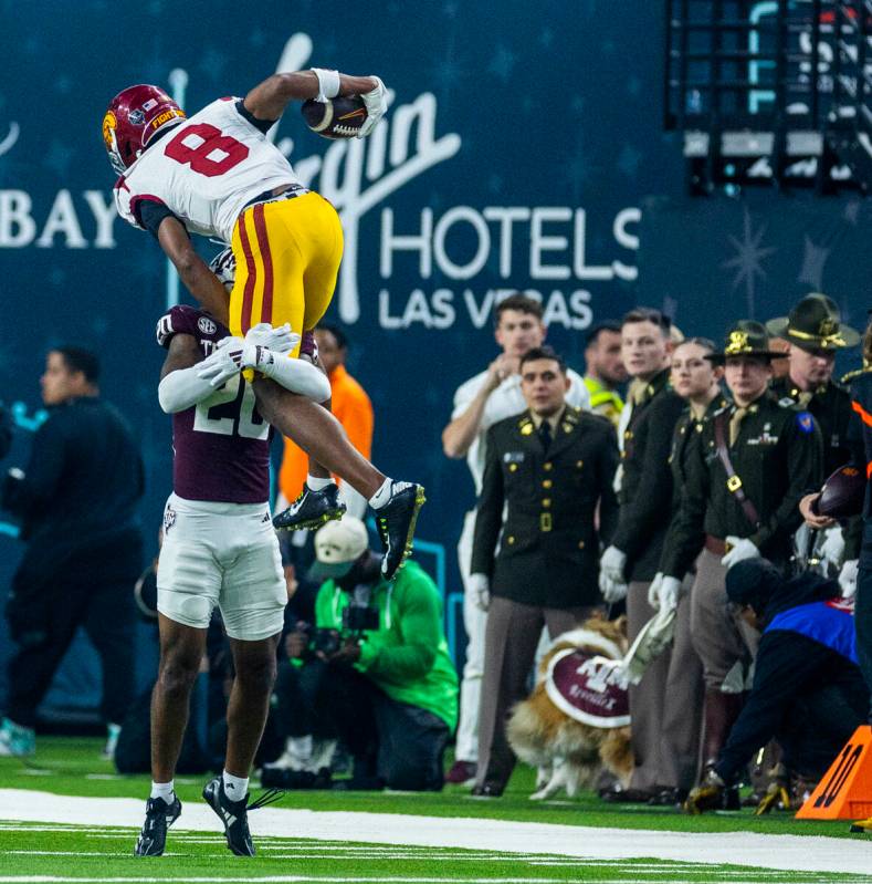 USC Trojans wide receiver Ja'Kobi Lane (8) attempts to go over Texas A&M Aggies defensive b ...