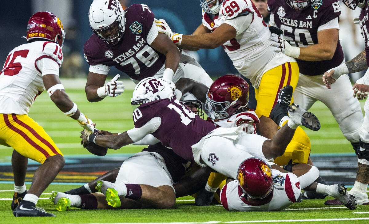 Texas A&M Aggies quarterback Marcel Reed (10) dives for a first down but is stopped short b ...