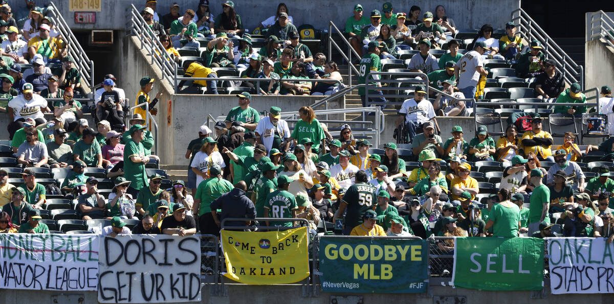 Oakland Athletics fans display signs as they watch the final home game against the Texas Ranger ...