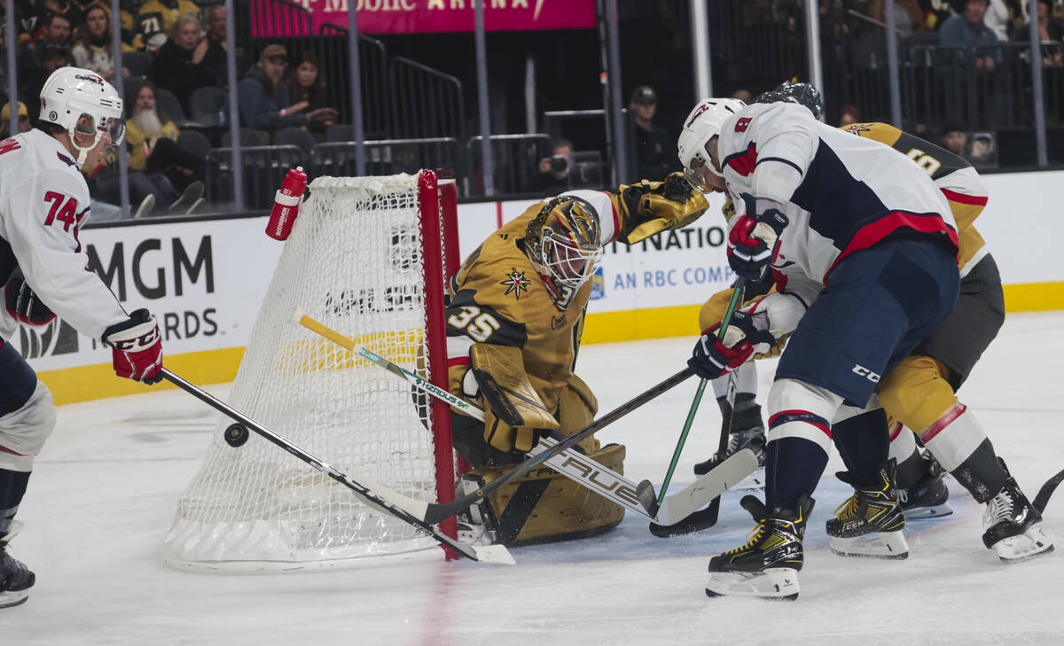 Golden Knights goaltender Ilya Samsonov (35) defends the net as Washington Capitals defenseman ...