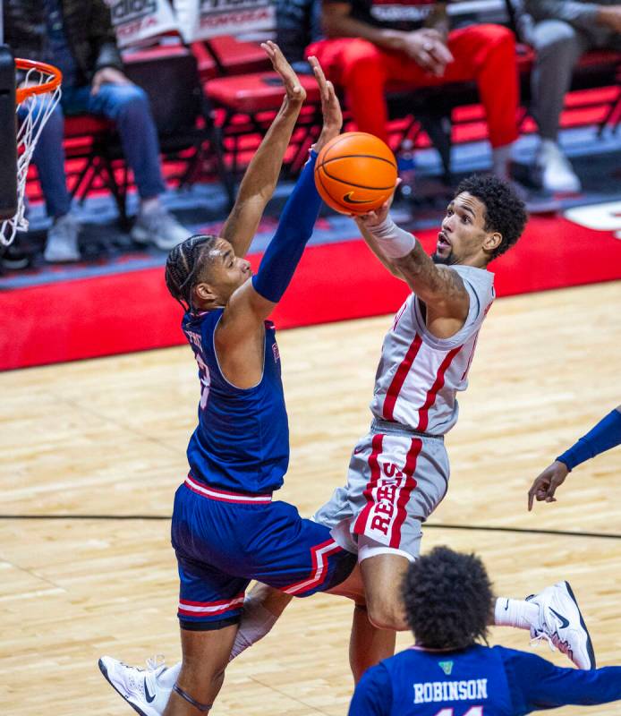 UNLV guard Jailen Bedford (14) looks to shoot around Fresno State Bulldogs forward Elijah Price ...