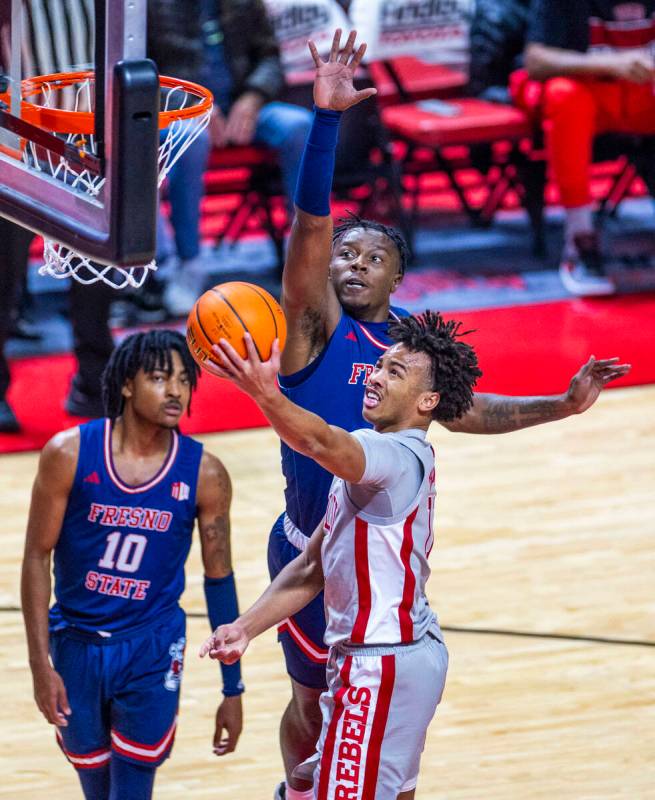 UNLV guard Dedan Thomas Jr. (11) gets inside of Fresno State Bulldogs guard Jalen Weaver (5) fo ...