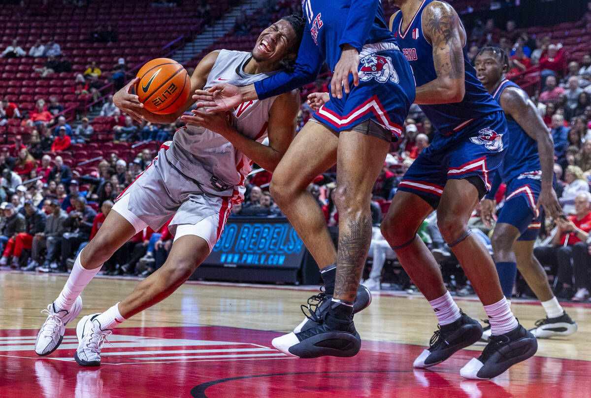 UNLV guard Jaden Henley (10) its founder by Fresno State Bulldogs forward Mykell Robinson (11) ...