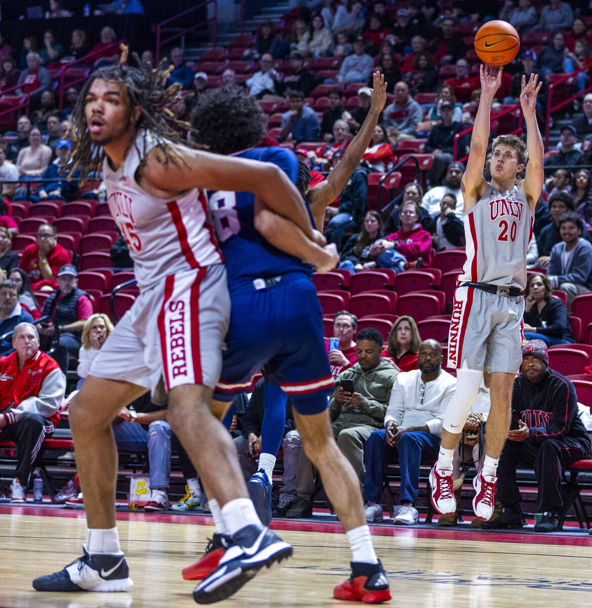 UNLV guard Julian Rishwain (20) releases a three-point shot against the Fresno State Bulldogs d ...