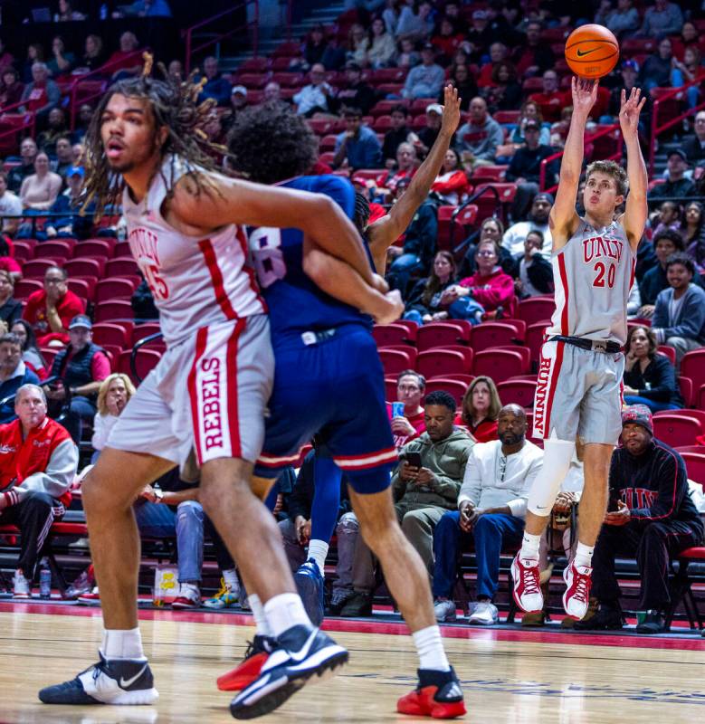 UNLV guard Julian Rishwain (20) releases a three-point shot against the Fresno State Bulldogs d ...