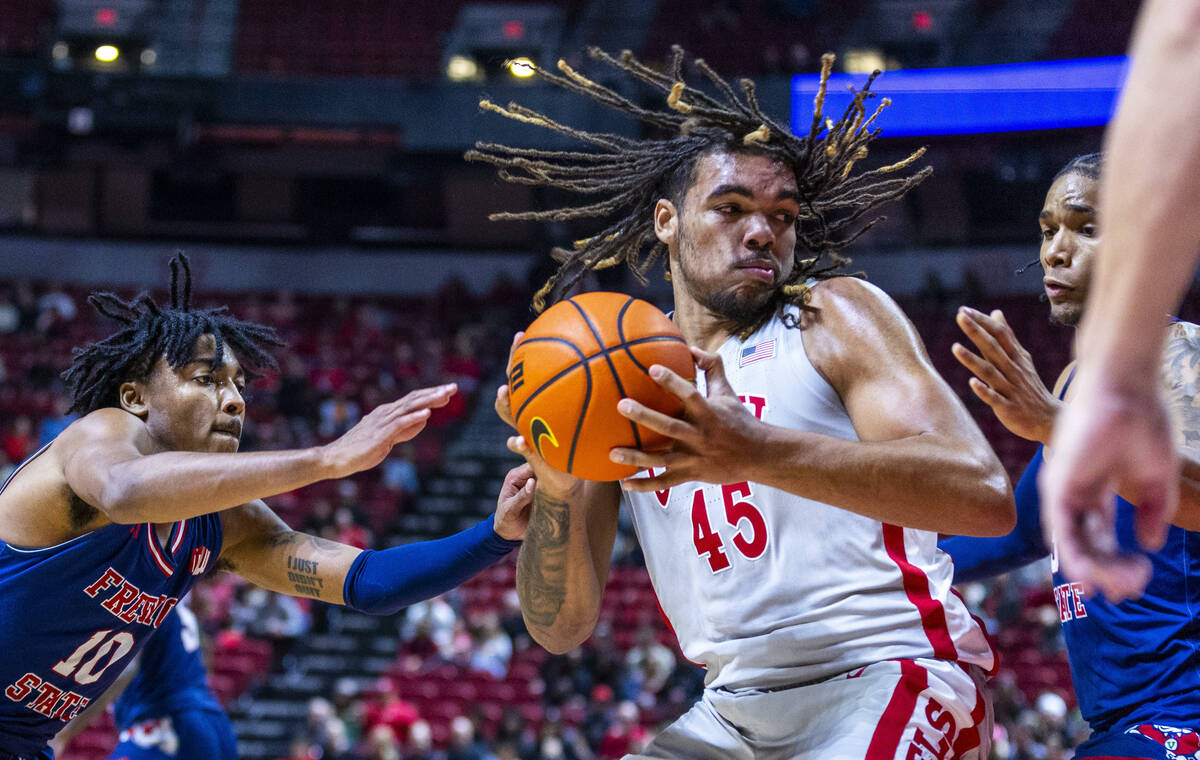 UNLV forward Jeremiah Cherry (45) looks for a shot against Fresno State Bulldogs forward Elijah ...