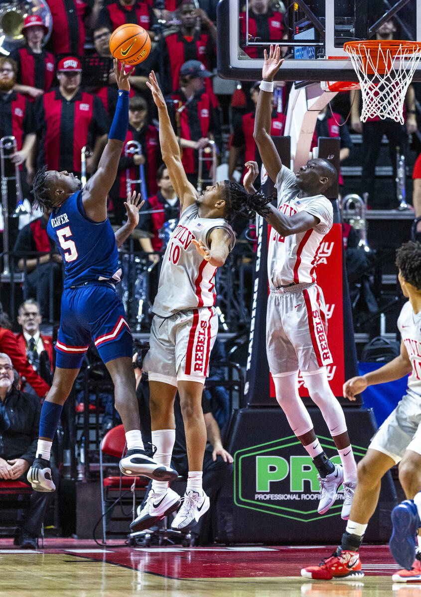 Fresno State Bulldogs guard Jalen Weaver (5) releases a shot against UNLV guard Jaden Henley (1 ...