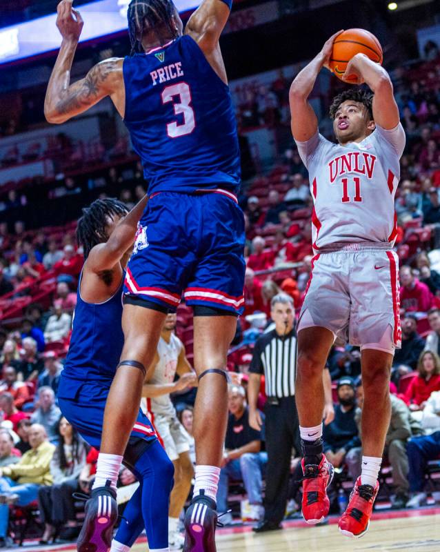 UNLV guard Dedan Thomas Jr. (11) looks to shoot against Fresno State Bulldogs forward Elijah Pr ...