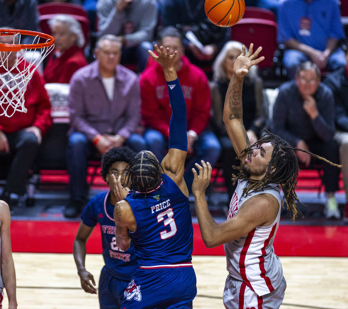 UNLV forward Jeremiah Cherry (45) gets off shot over Fresno State Bulldogs forward Elijah Price ...