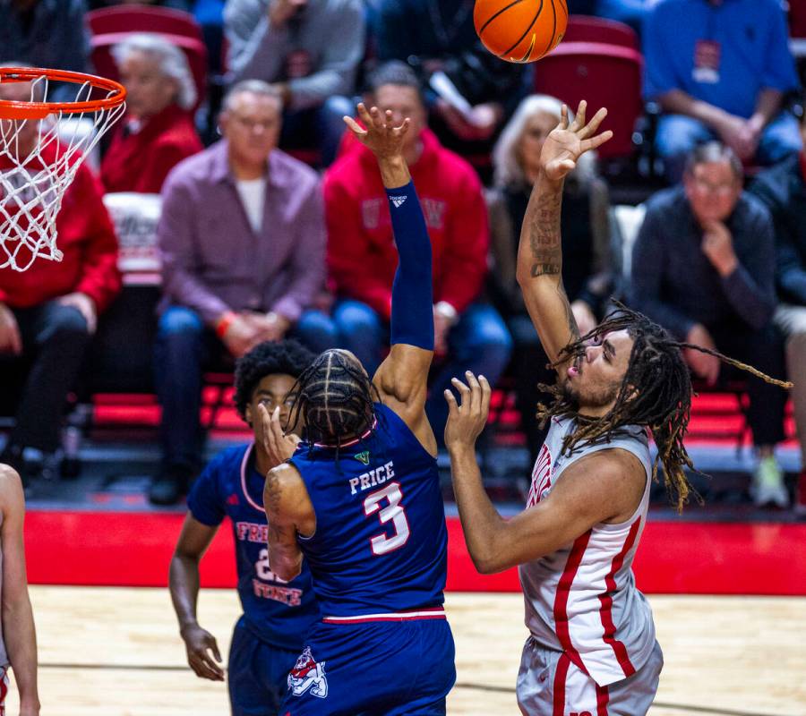 UNLV forward Jeremiah Cherry (45) gets off shot over Fresno State Bulldogs forward Elijah Price ...