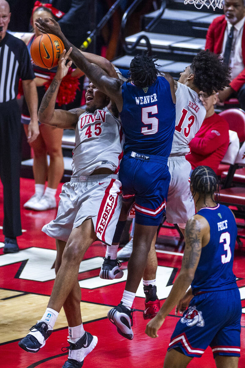 UNLV forward Jeremiah Cherry (45) battles for a rebound with Fresno State Bulldogs guard Jalen ...