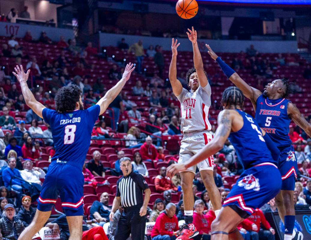 UNLV guard Dedan Thomas Jr. (11) elevates for a three-point basket over Fresno State Bulldogs g ...