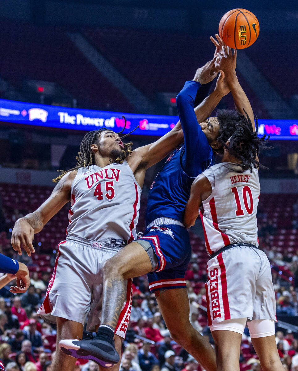 UNLV forward Jeremiah Cherry (45) battles for a rebound with Fresno State Bulldogs forward Myke ...