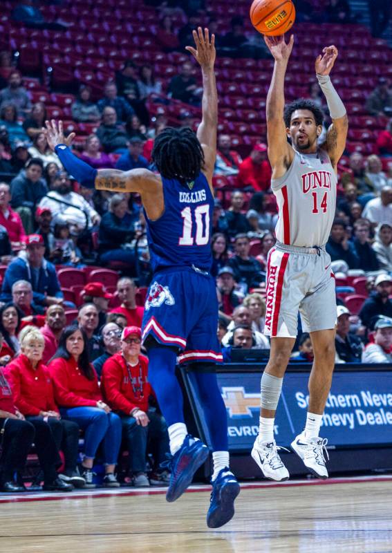 UNLV guard Jailen Bedford (14) gets off a three-point basket over Fresno State Bulldogs guard Z ...