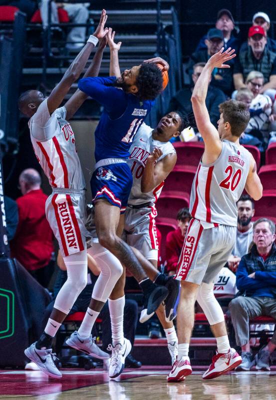 UNLV forward Pape N'Diaye (22) rejects a shot by Fresno State Bulldogs forward Mykell Robinson ...