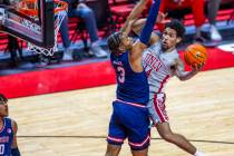 UNLV guard Jailen Bedford (14) looks to shoot around Fresno State Bulldogs forward Elijah Price ...