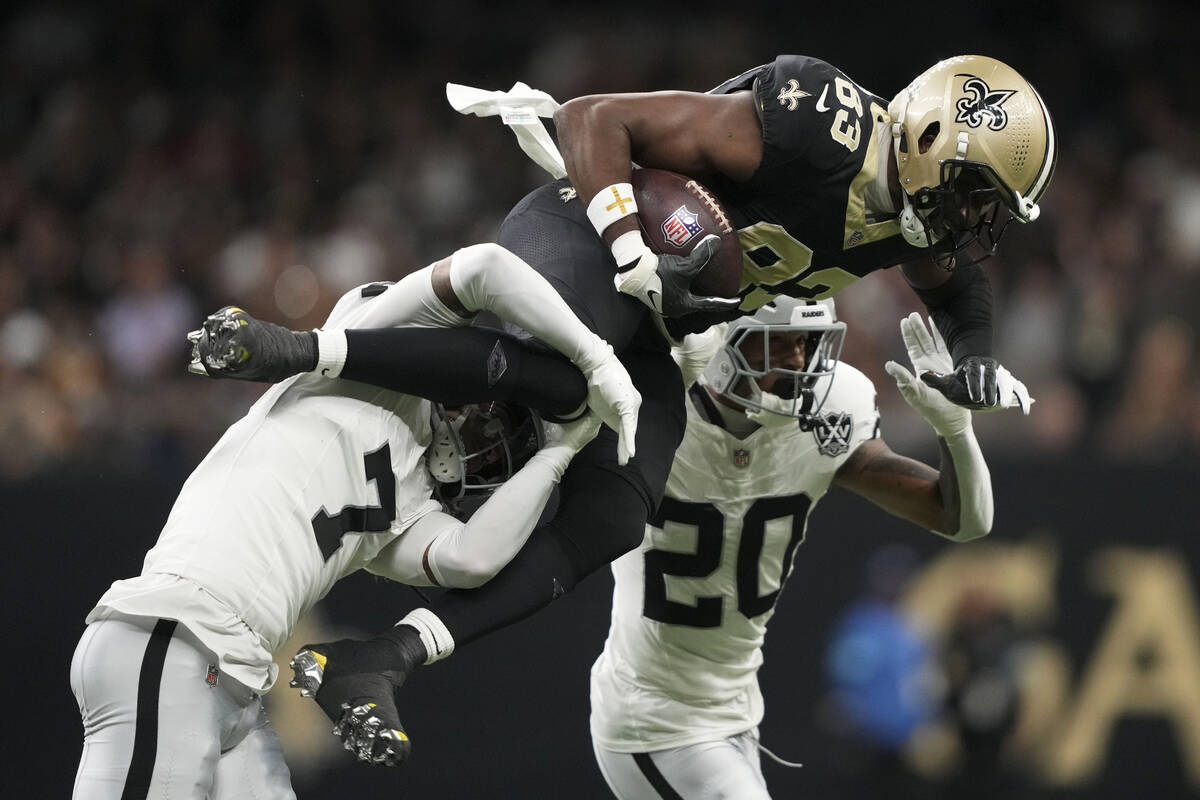 New Orleans Saints tight end Juwan Johnson (83) is tackled by Las Vegas Raiders safety Tre'von ...