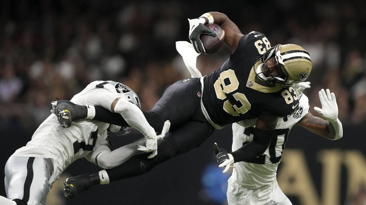 New Orleans Saints tight end Juwan Johnson (83) is tackled by Las Vegas Raiders safety Tre'von ...