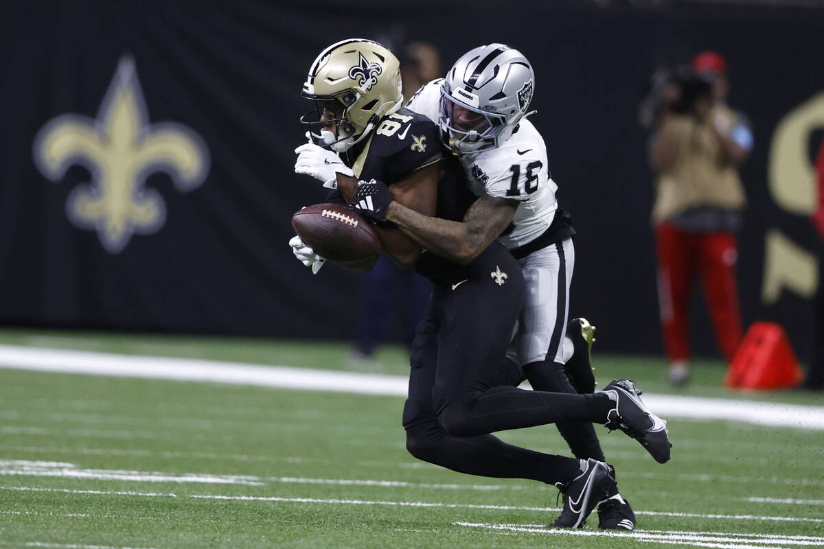 Las Vegas Raiders cornerback Jack Jones (18) breaks up a pass intended for New Orleans Saints w ...