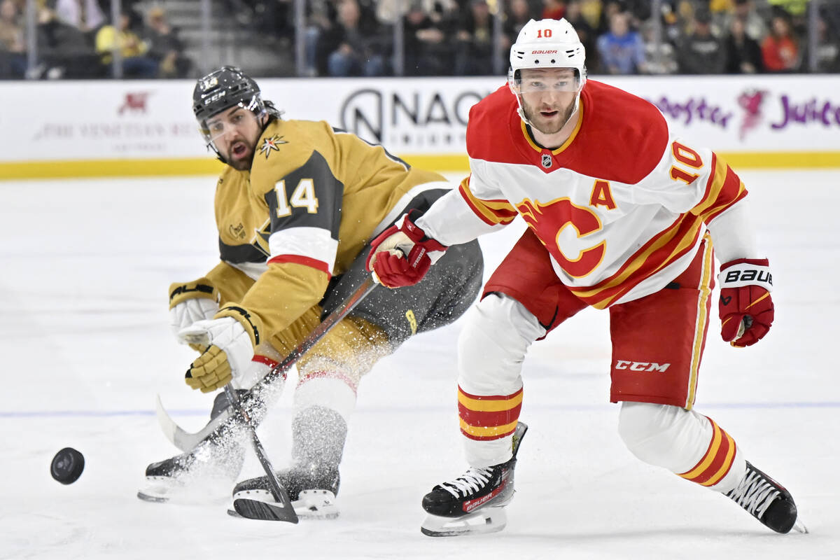 Vegas Golden Knights defenseman Nicolas Hague (14) and Calgary Flames center Jonathan Huberdeau ...