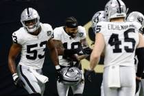 Las Vegas Raiders cornerback Jack Jones (18) celebrates with teammates after intercepting a pas ...