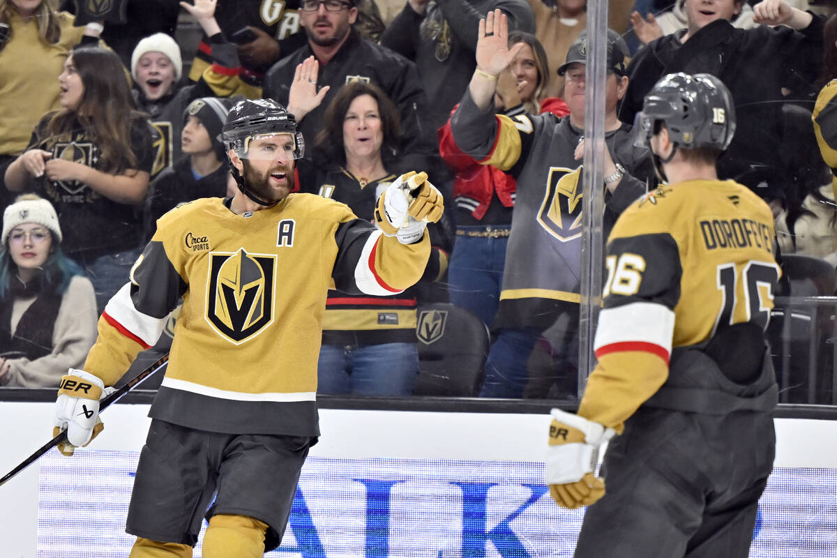 Vegas Golden Knights defenseman Alex Pietrangelo, left, reacts after scoring against the Calgar ...