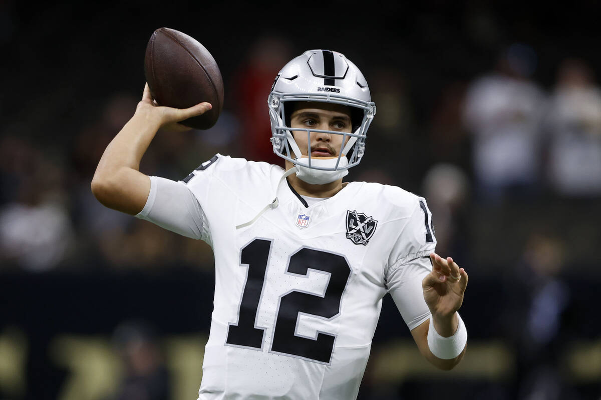 Las Vegas Raiders quarterback Aidan O'Connell warms up before an NFL football game against the ...