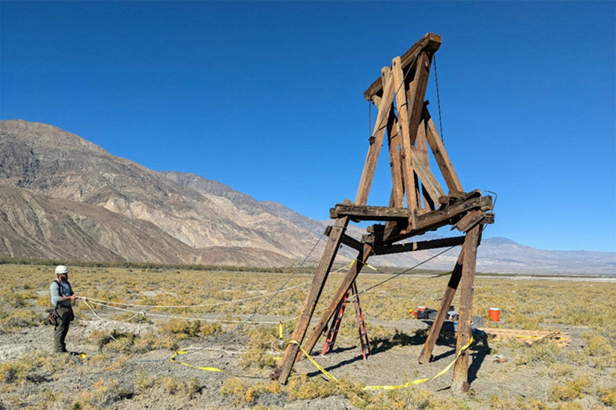 Photo 1 of 3 in series of the same tower. A National Park Service preservationist attaches rope ...