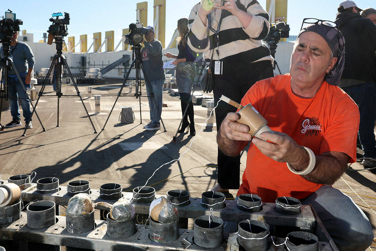 Fireworks by Grucci pyro technician and crew chief Louis DeLeo talks to a reporter while settin ...