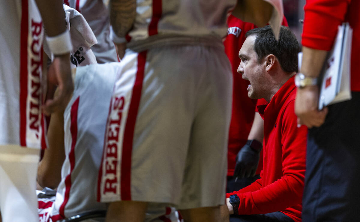 UNLV head coach Kevin Kruger instructs his players on a time out versus the Fresno State Bulldo ...