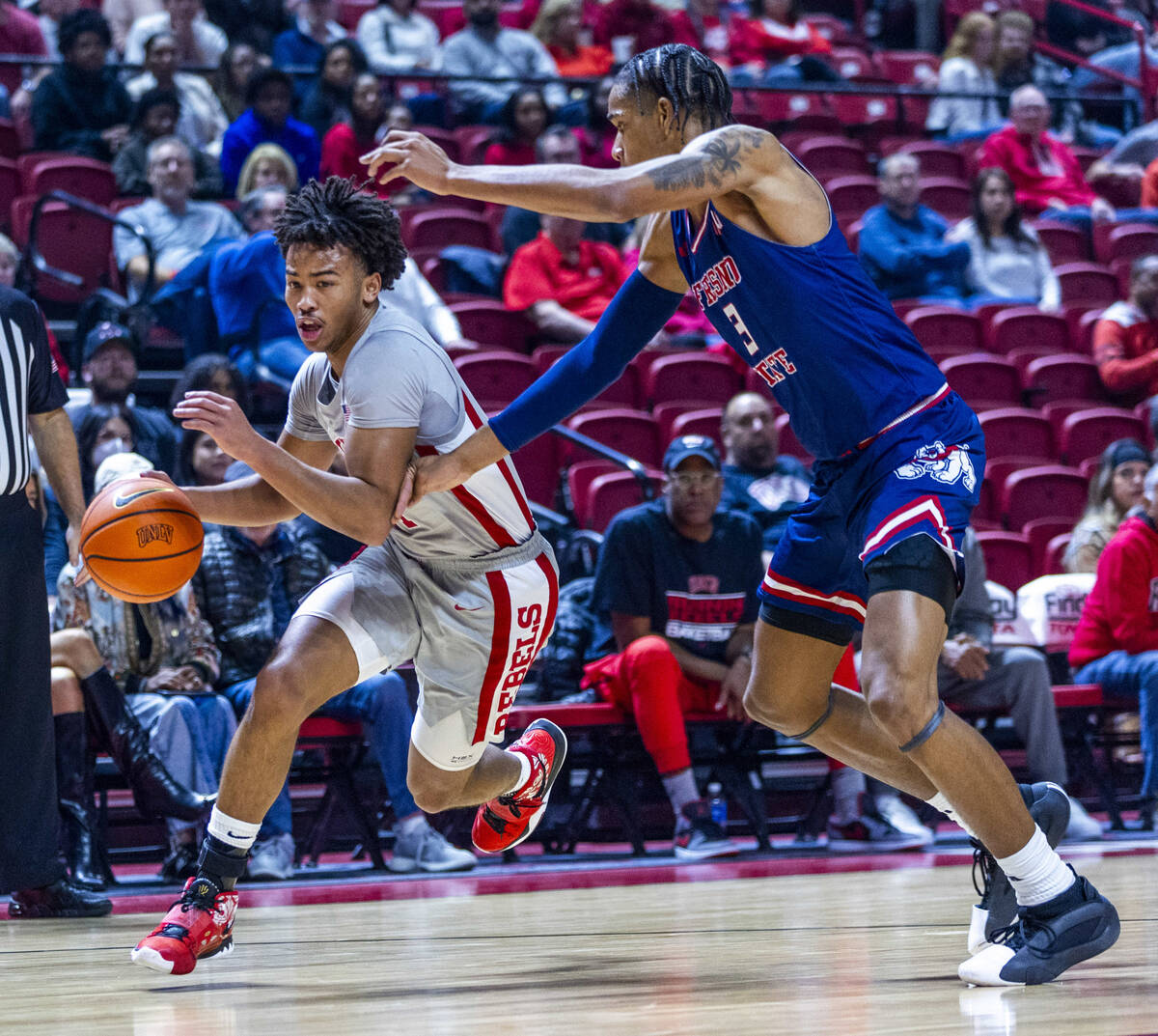 UNLV guard Dedan Thomas Jr. (11) drives the lane against Fresno State Bulldogs forward Elijah P ...