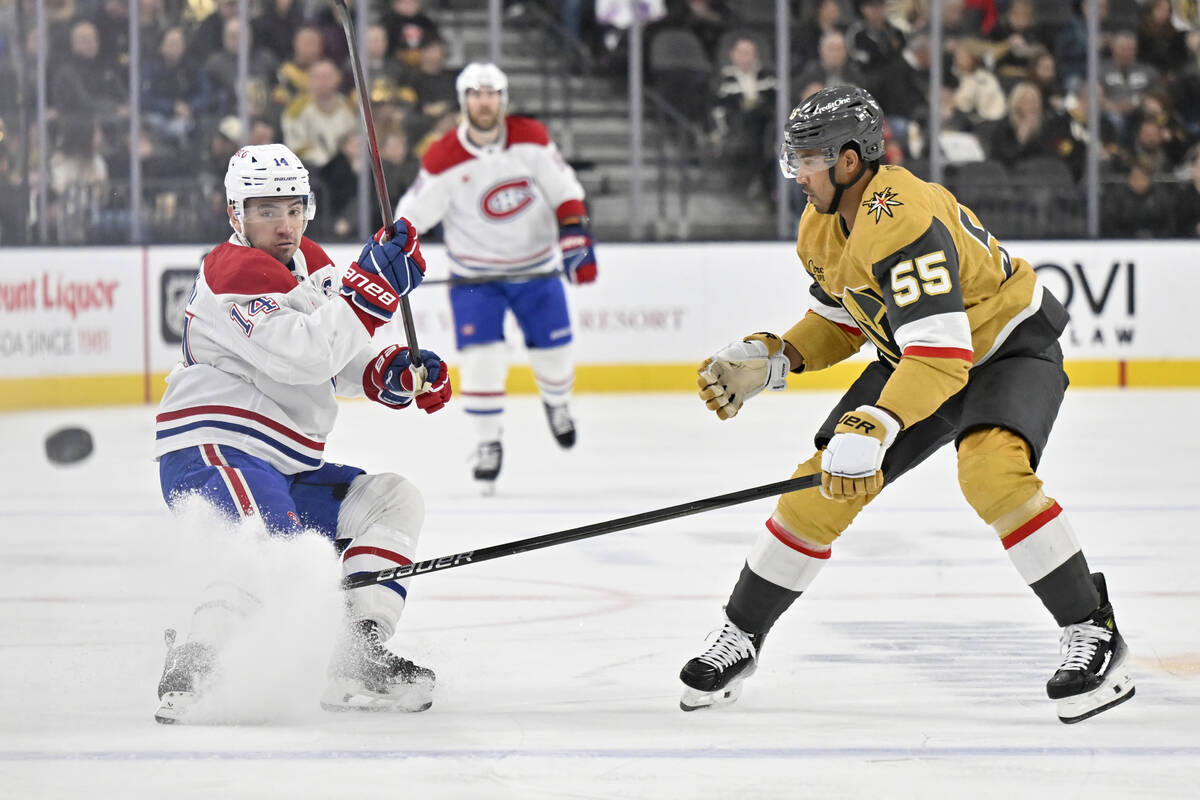 Montreal Canadiens center Nick Suzuki (14) hits the puck down ice against Vegas Golden Knights ...