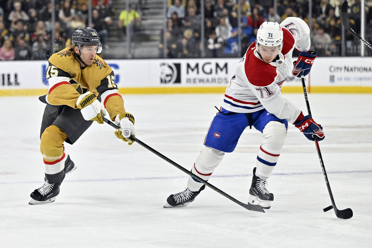 Vegas Golden Knights defenseman Noah Hanifin (15) and Montreal Canadiens center Jake Evans (71) ...