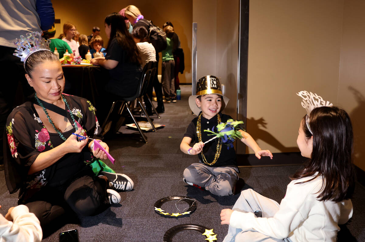 Jennifer Loussia, left, makes crafts with her children Jace, 4, and Amelia, 7, during “N ...