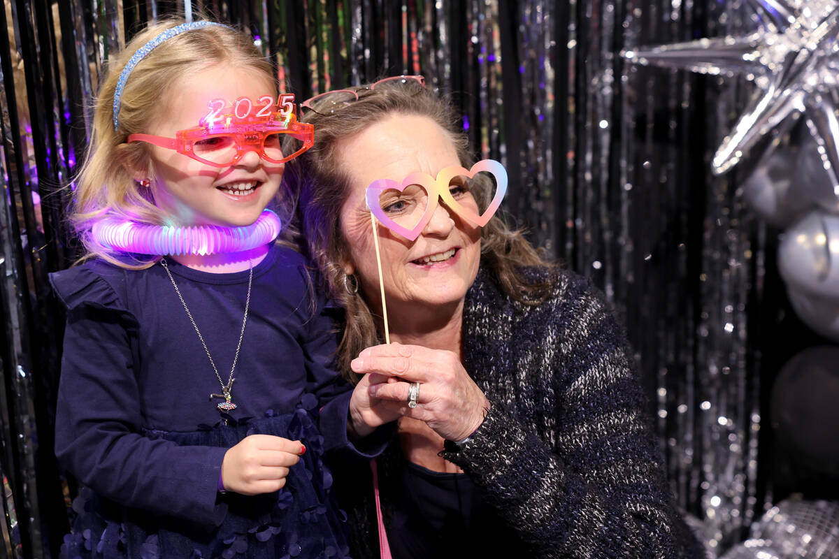 Remi Malady, 5, and her grandmother Dawn Henderson pose during “Noon Year’s Eve&# ...