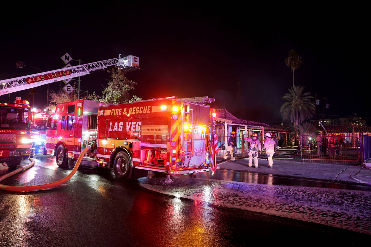 Las Vegas firefighters work a fire at the former Lucky Motel on East Fremont Street in downtown ...