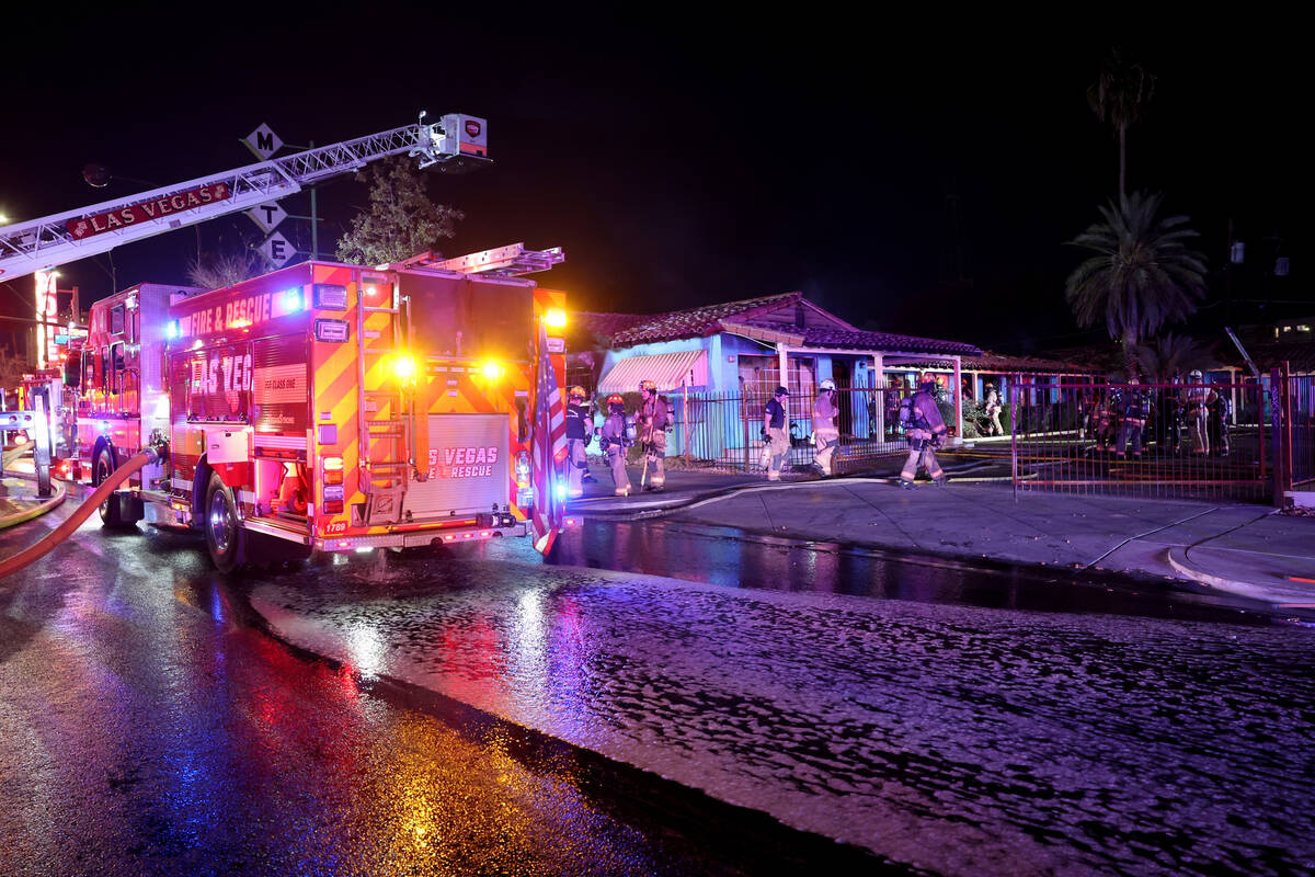 Las Vegas firefighters work a fire at the former Lucky Motel on East Fremont Street in downtown ...