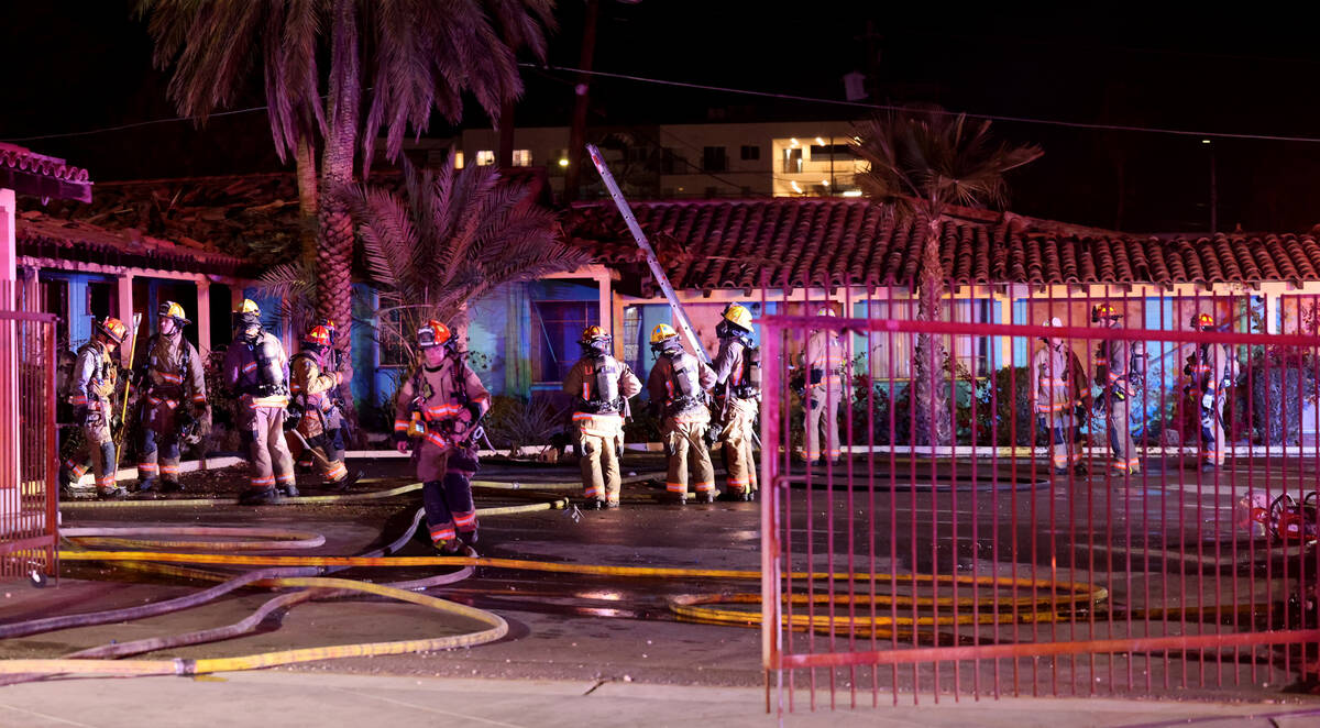 Las Vegas firefighters work a fire at the former Lucky Motel on East Fremont Street in downtown ...