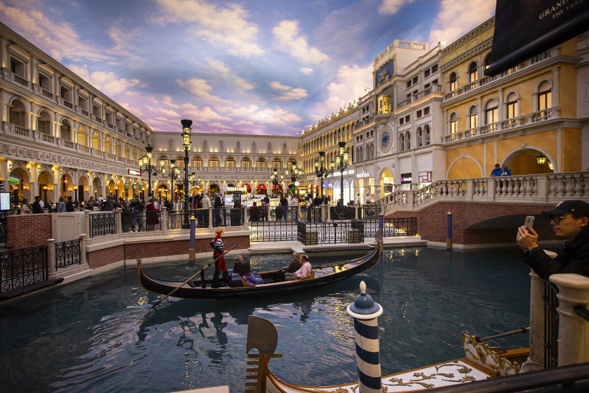 People take a gondola ride at the Grand Canal Shoppes at The Venetian on Thursday, Dec. 12, 202 ...