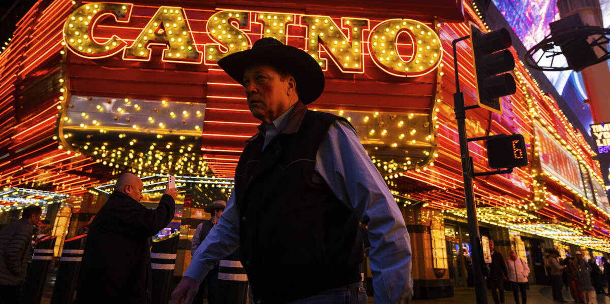 People walk along the Fremont Street Experience on Wednesday, Dec. 11, 2024, in Las Vegas. (Cha ...