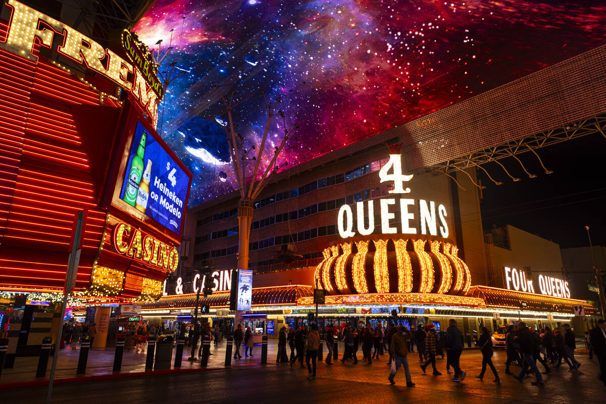 People walk along the Fremont Street Experience on Wednesday, Dec. 11, 2024, in Las Vegas. (Cha ...